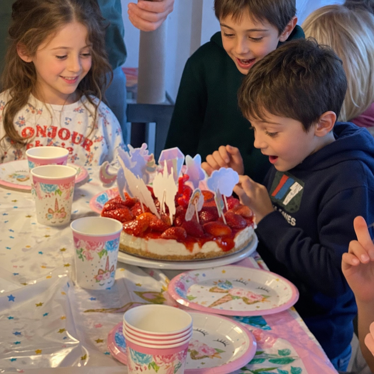 Children enjoying a birthday cake together at the studio