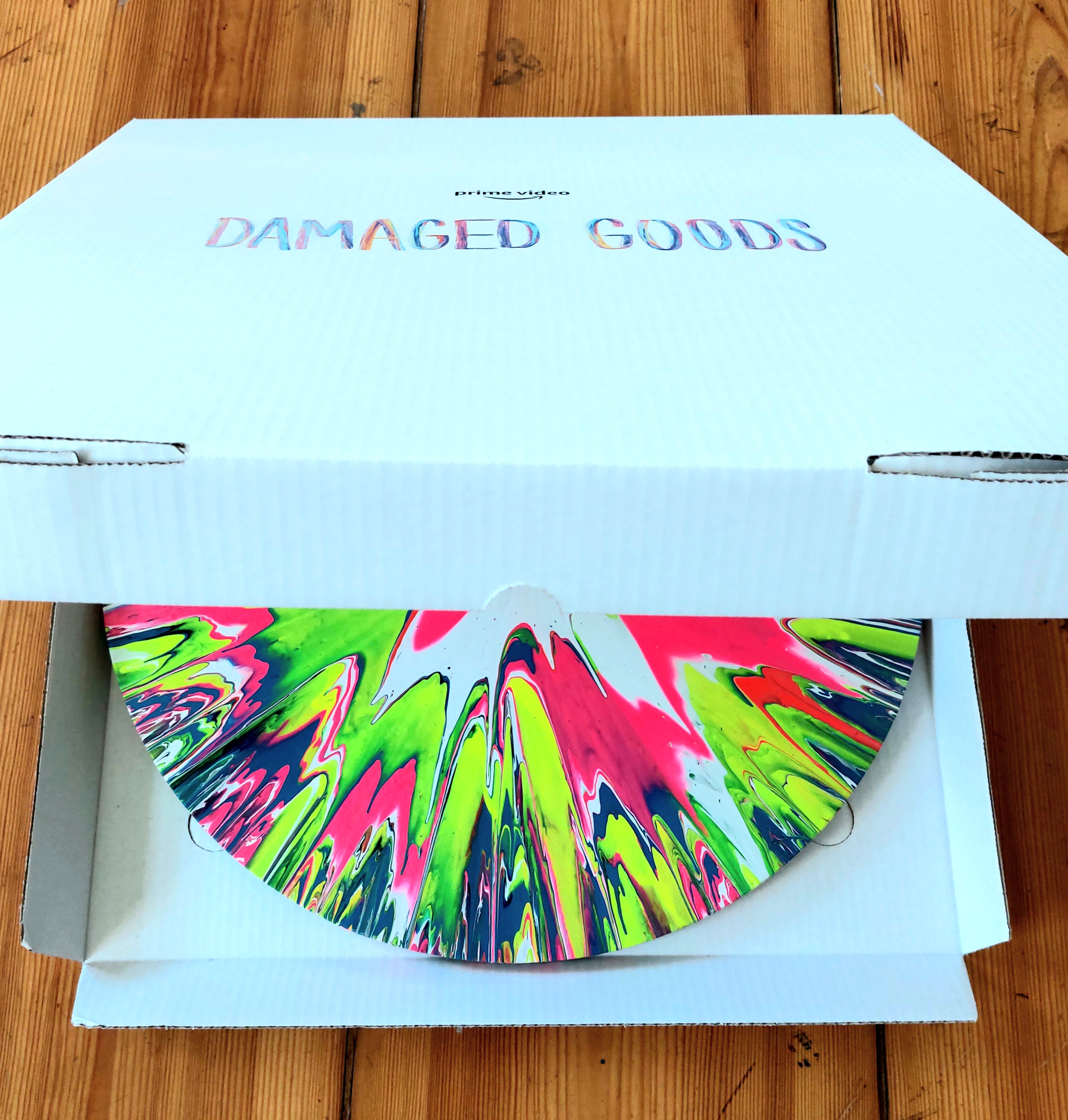 Round spin painting in a personalised Damaged Goods transport box