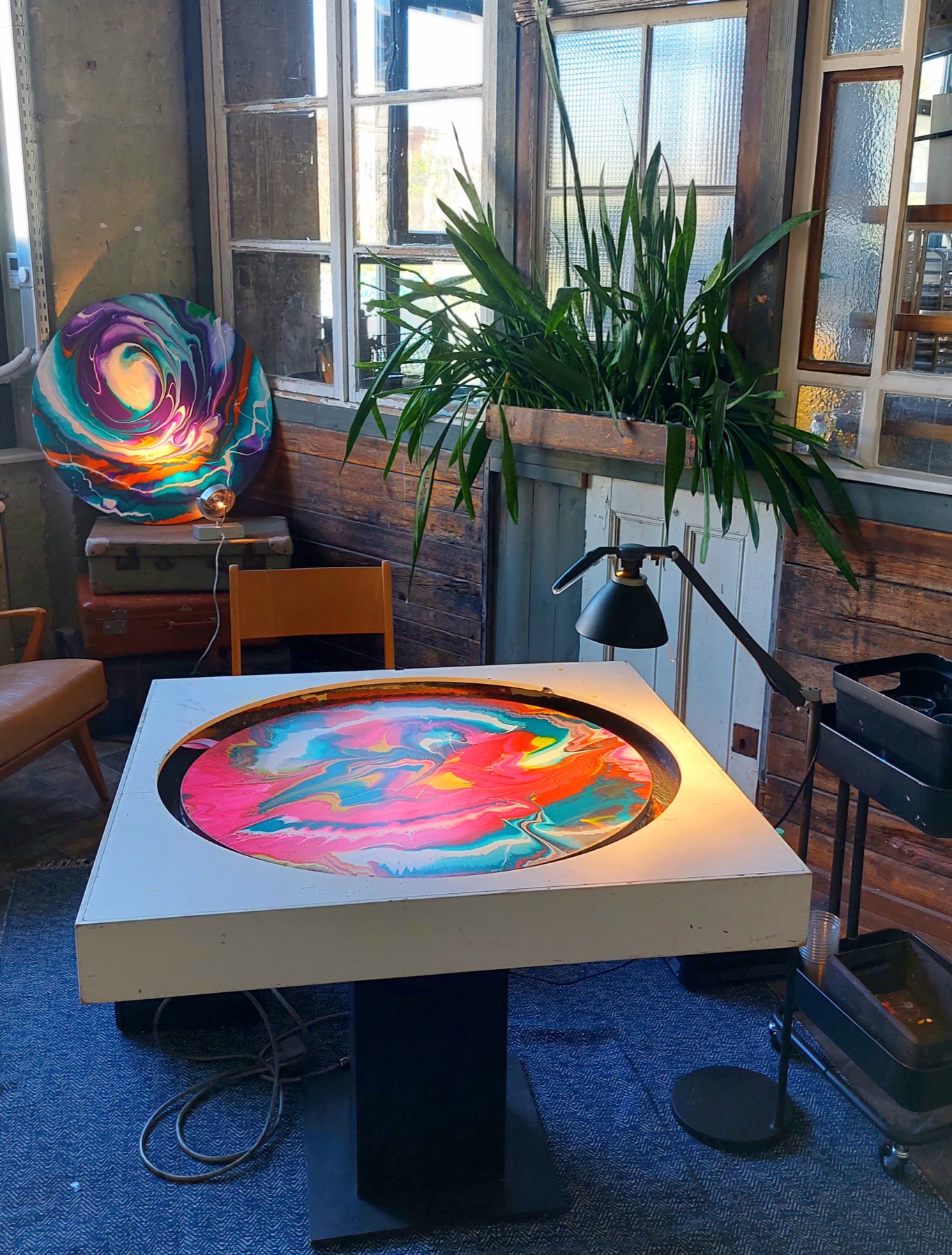 Mobile spin painting machine with a colourful artwork at an event venue